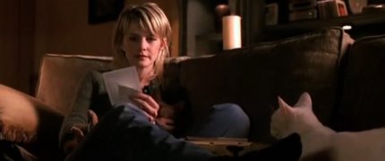 Lilly looks at some photos with her cats